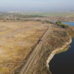 River, big field, dirt road, and levee