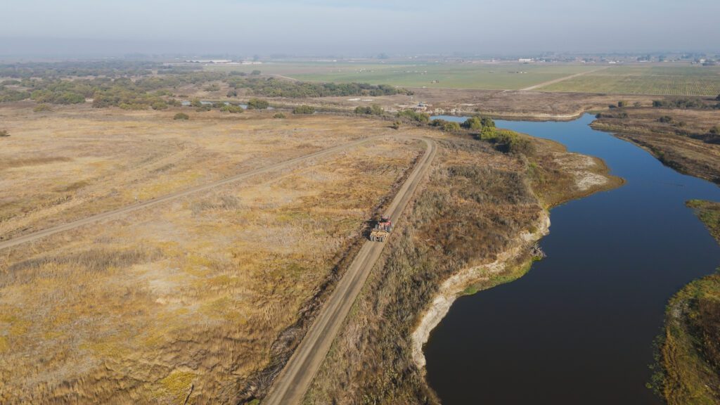 River, big field, dirt road, and levee